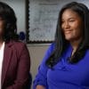 Two students Calcea Johnson and Ne'Kiya Jackson interview in classroom for the news. The girl on the left is wearing a white shirt with a burgundy blazer on top and glasses with short curled hair and the one on the right is wearing long straight hair with a blue blouse.